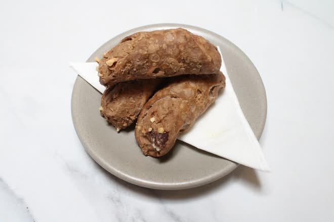 Chocolate cannoli on a grey plate
