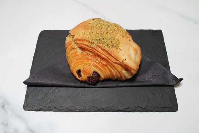 Pistachio pain au chocolat on a slate board