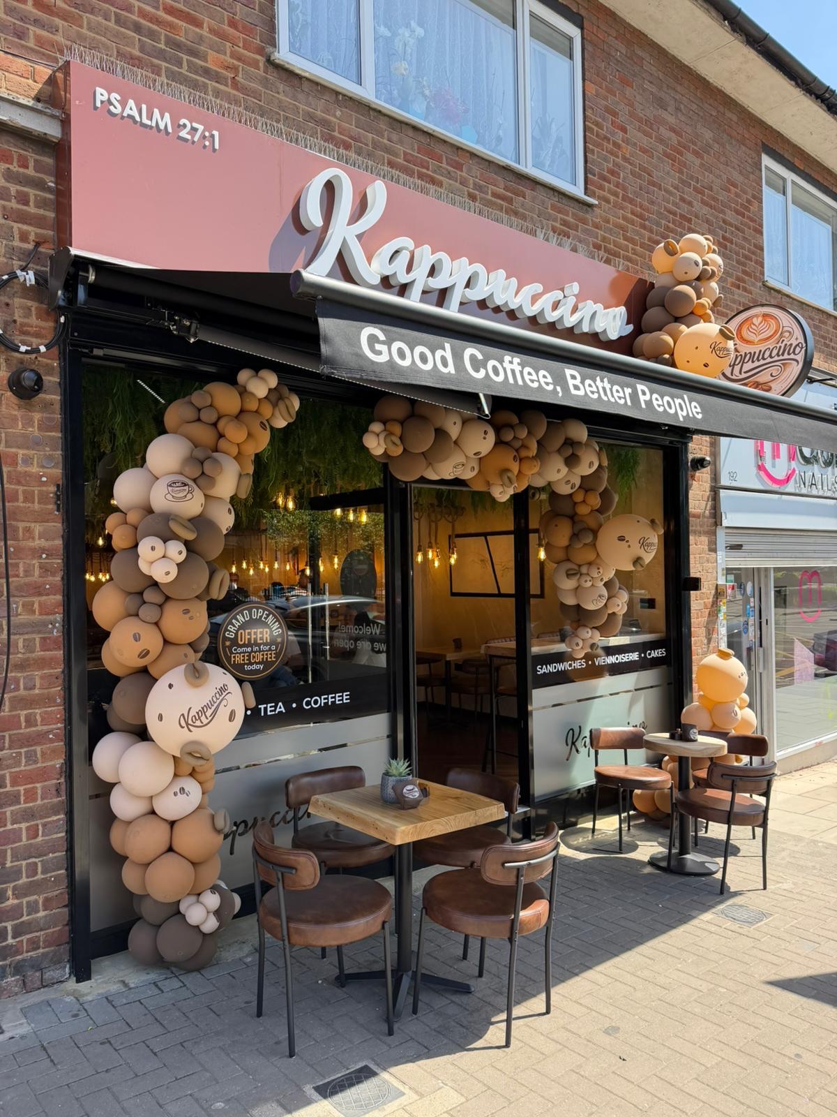 Kappuccino shopfront on Preston Road with its rose awning, balloon arch and outdoor tables