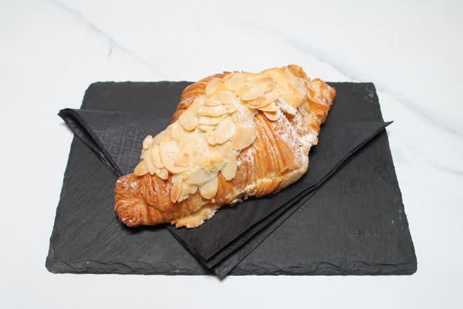 Almond croissant on a slate board
